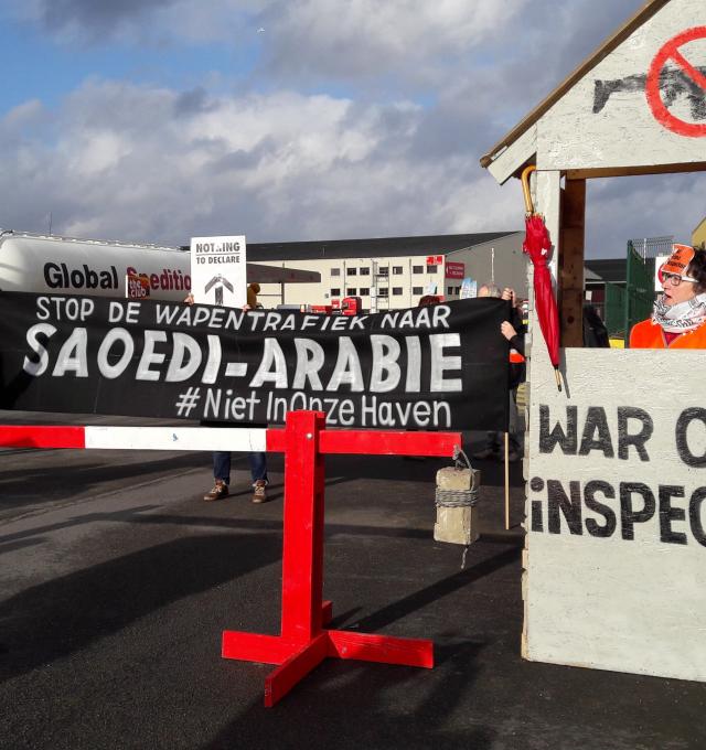 Action at the port of Antwerp - banner says stop arming saudi in Dutch